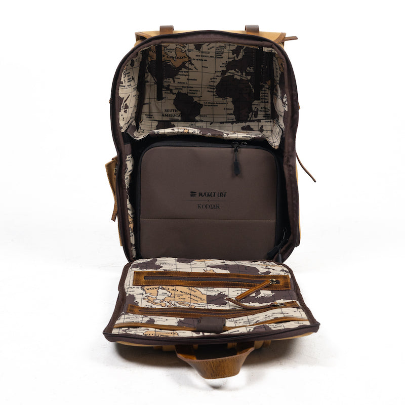 Product photo of the inside of a backpack with two compartments. One compartment has a brown camera cube inside.