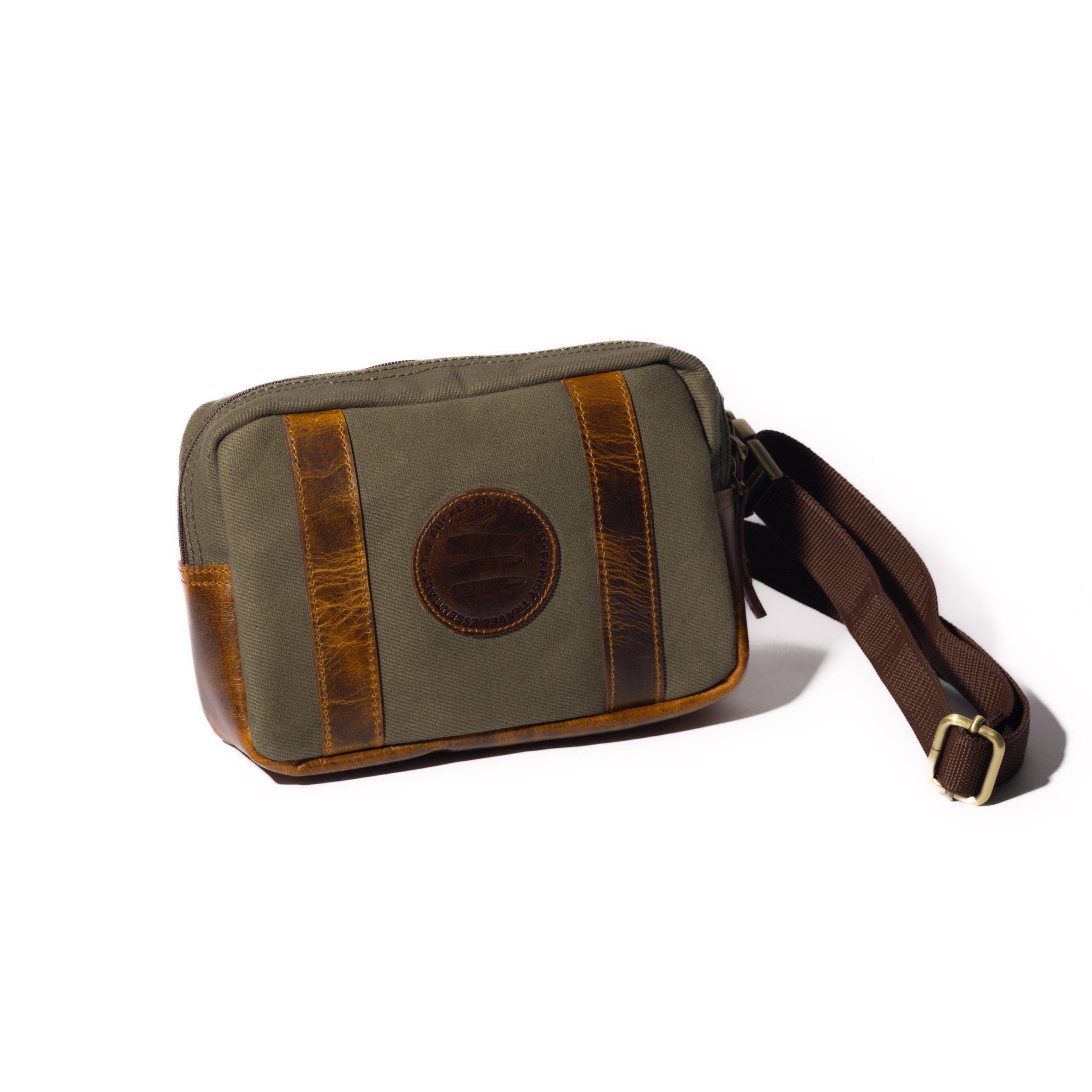 Product image of a vintage sage canvas and leather crossbody belt bag with a white background.