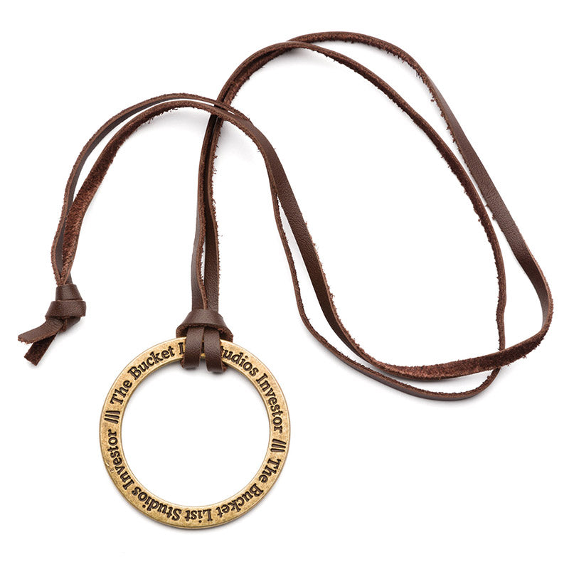 Product image of a necklace with a large metal ring that says The Bucket List Studios Investor on it. The necklace strap is leather.
