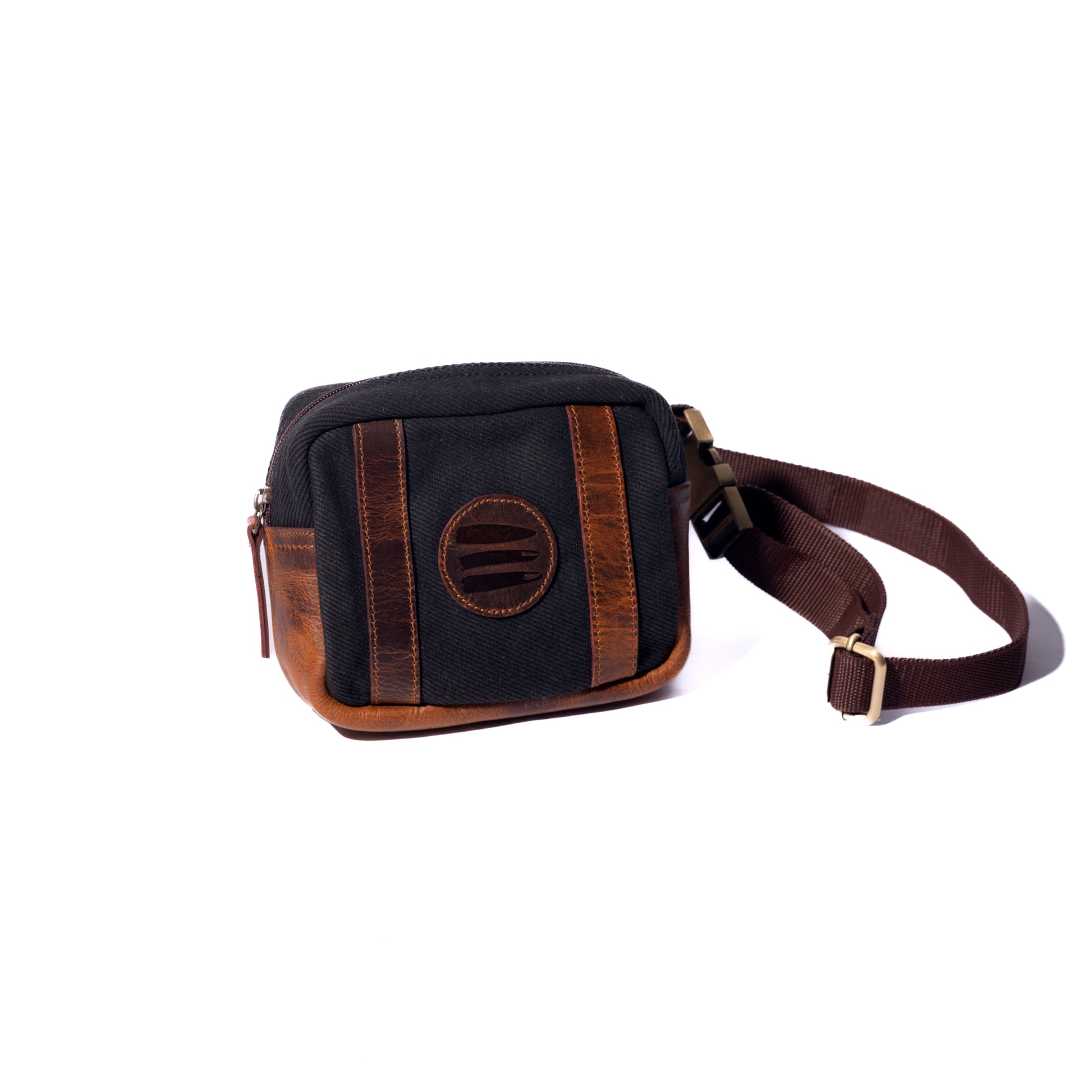 Product photo of a black canvas and leather belt bag with a white background.