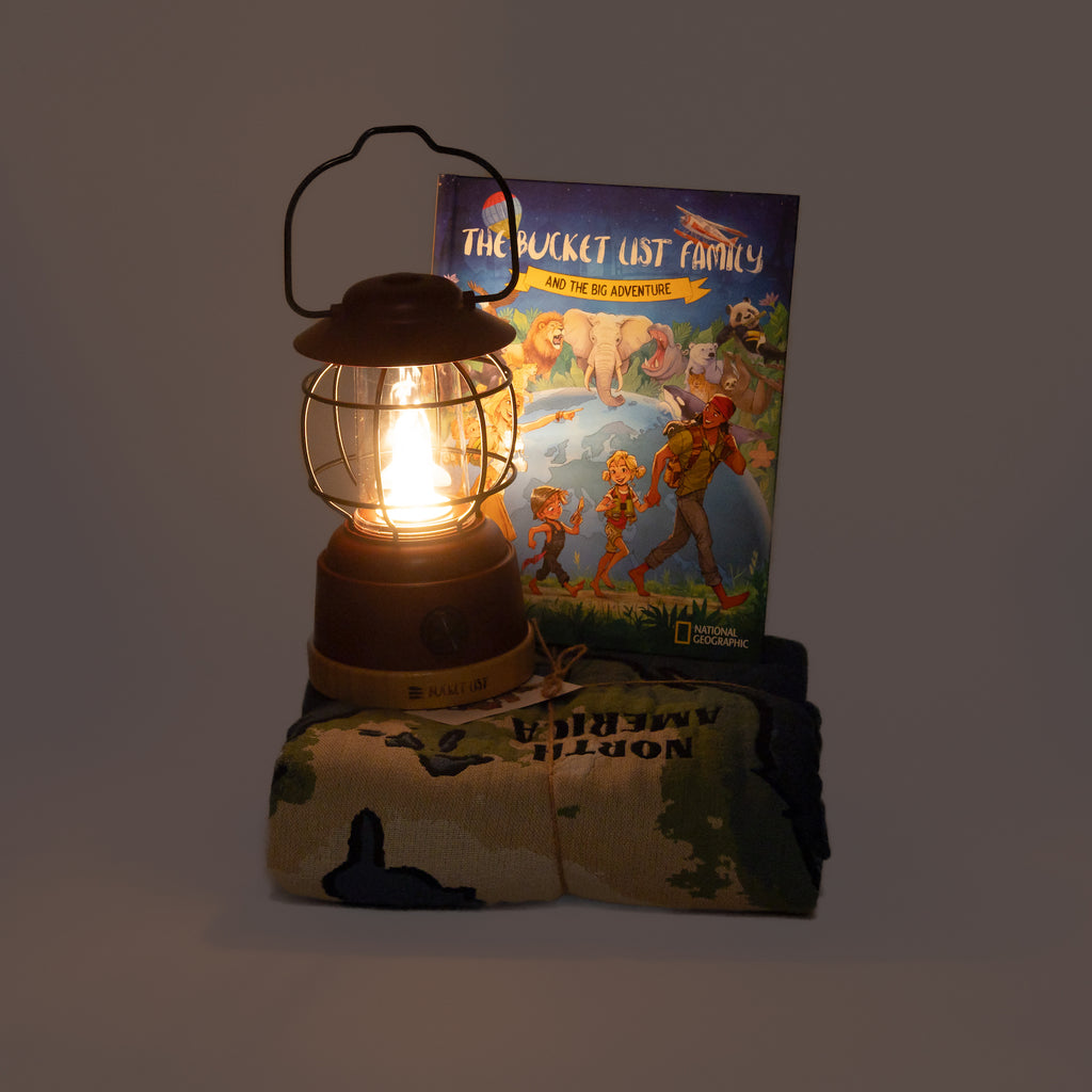 Lighted lantern next to a children's book on a dark background