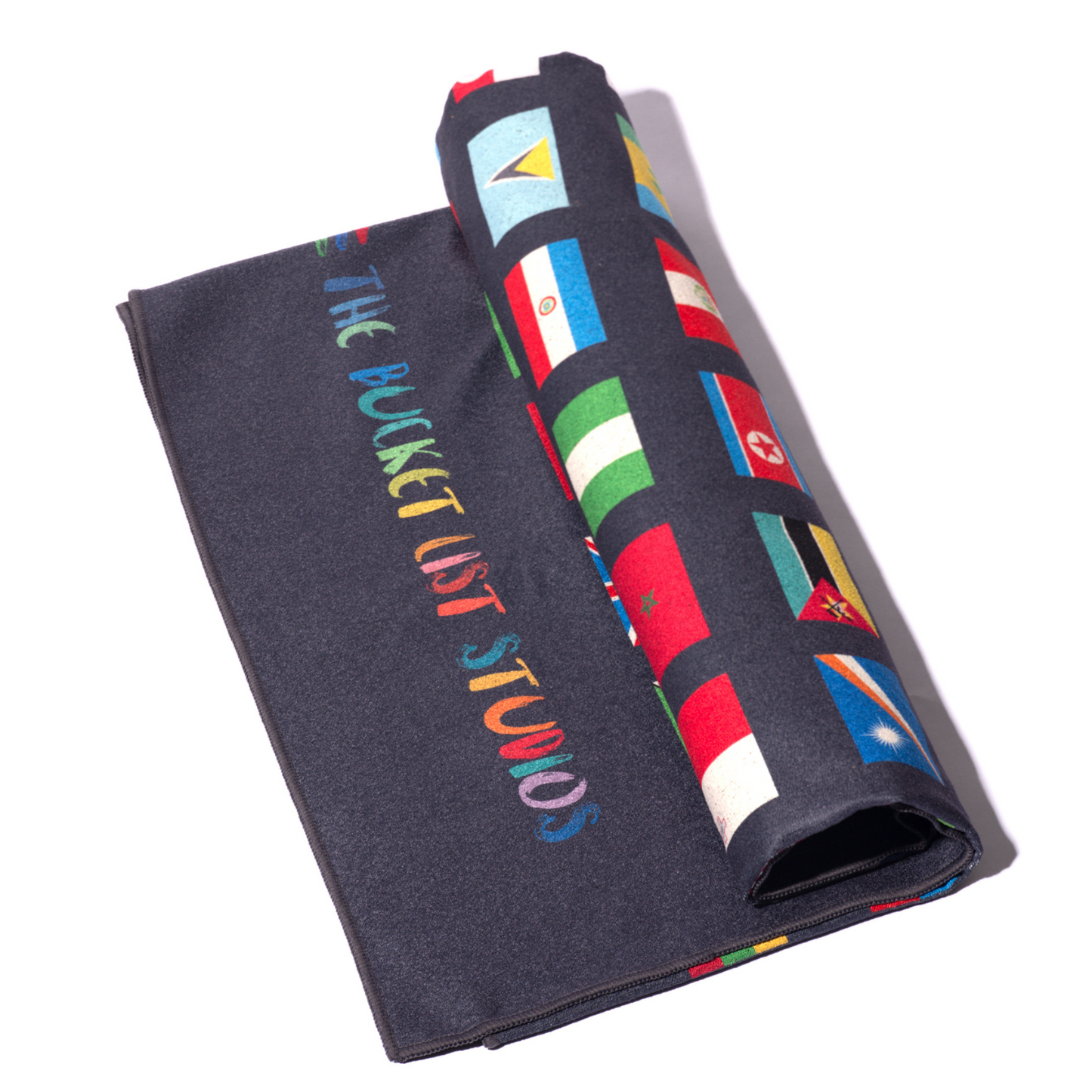 Product photo of the black Flags of the World Blanket rolled up with white background.