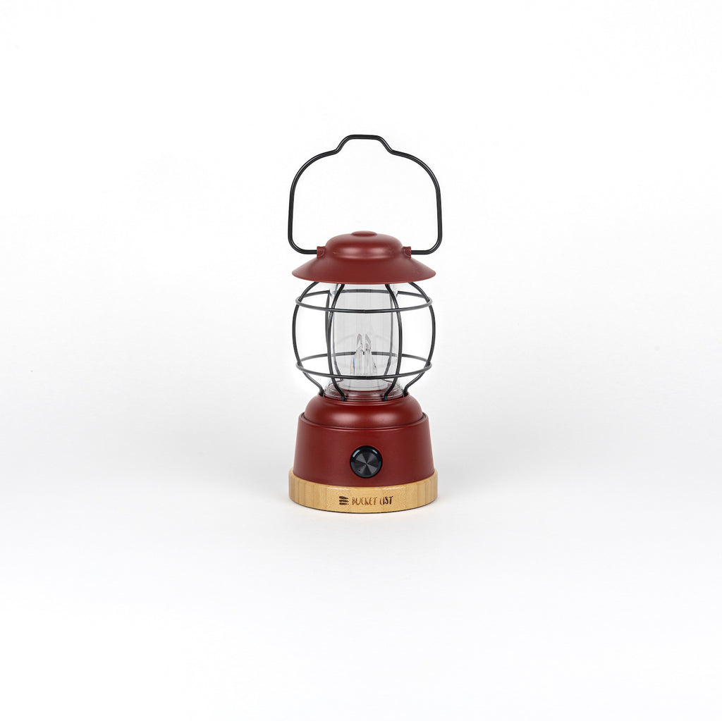 Red lantern with a black handle on a white background