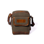 Product photo of a vintage sage sling pouch with a white background.