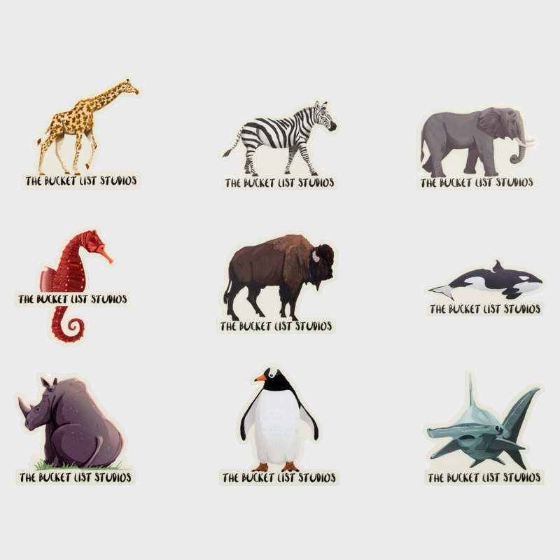 Image of nine different wildlife animal stickers that include a giraffe, zebra, elephant, seahorse, bison, orca, rhino, penguin, and hammerhead. 