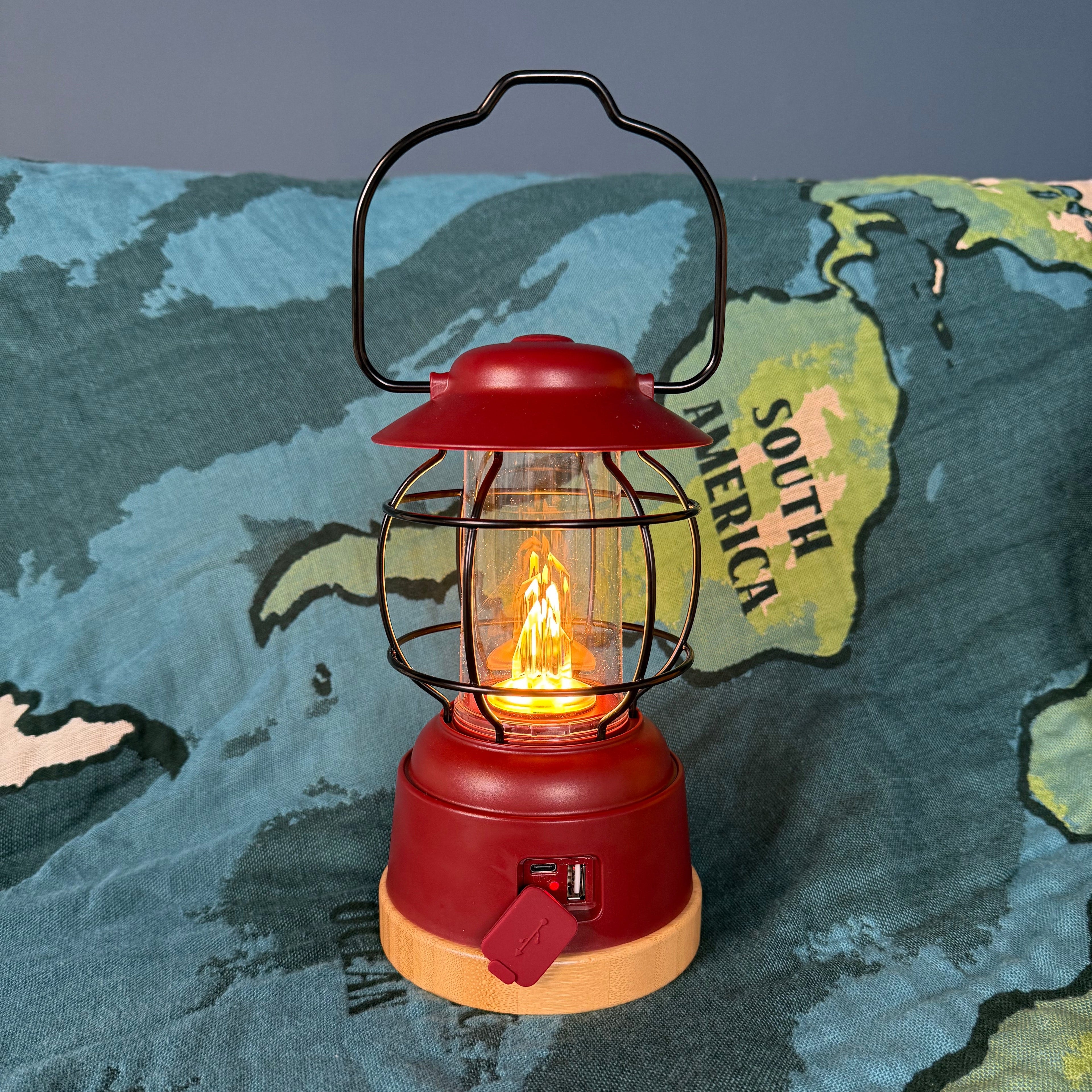 Red lantern with a lit bulb on a world map background