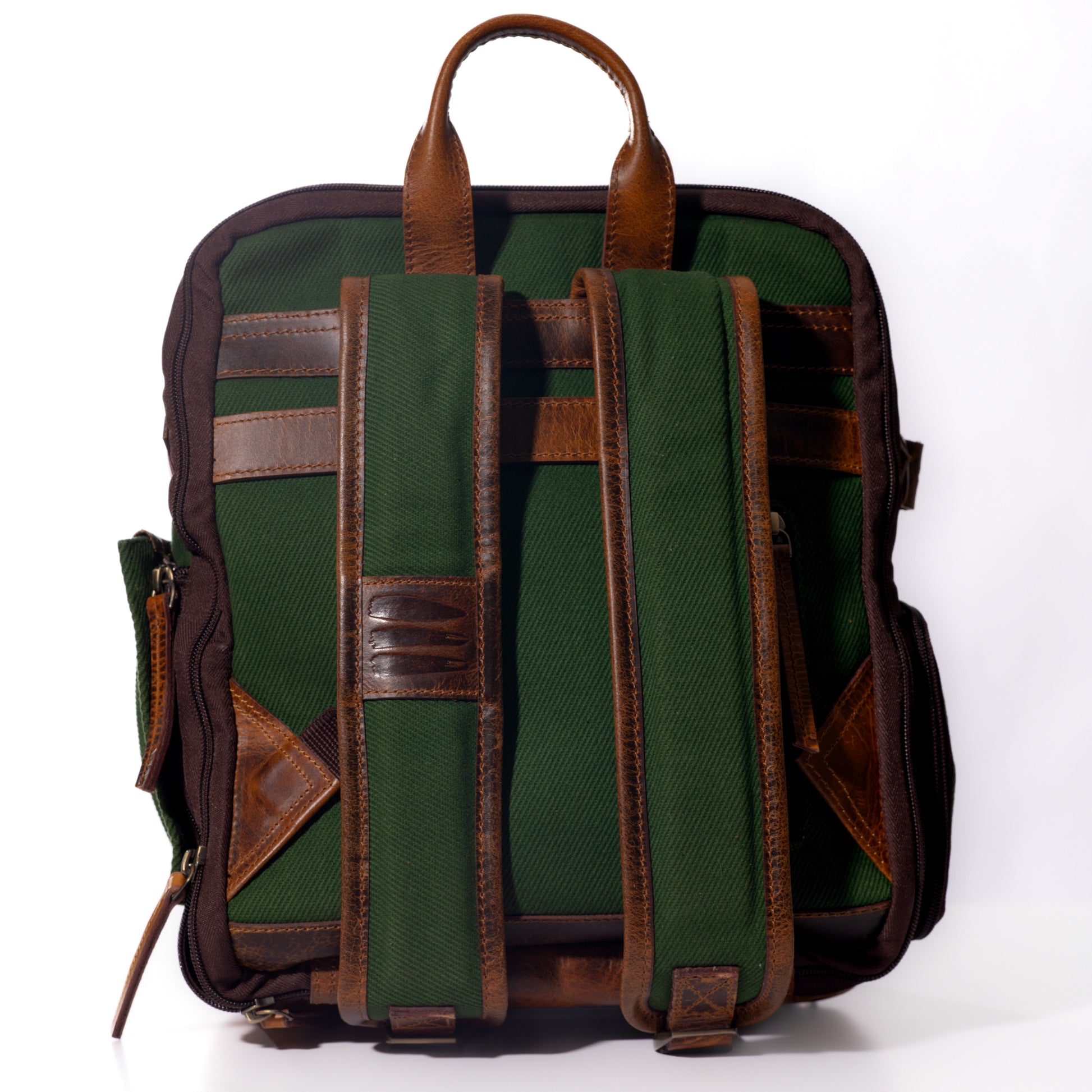 Product photo of the back of a green canvas and leather backpack.