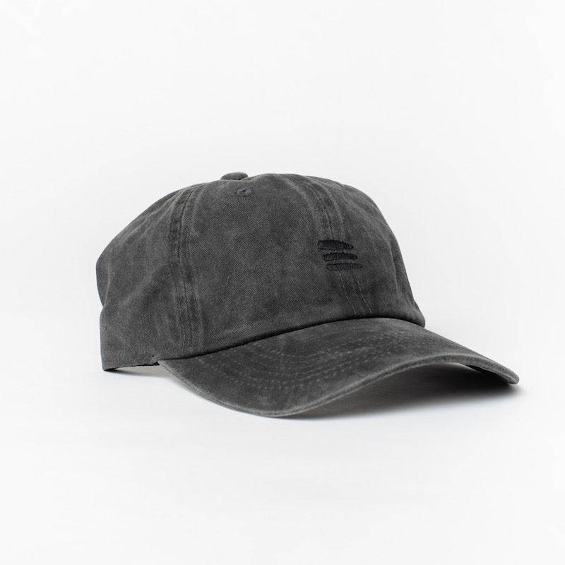 Product photo with a white background of a black baseball cap with a black embroidered bucket list logo on the front of the cap. 