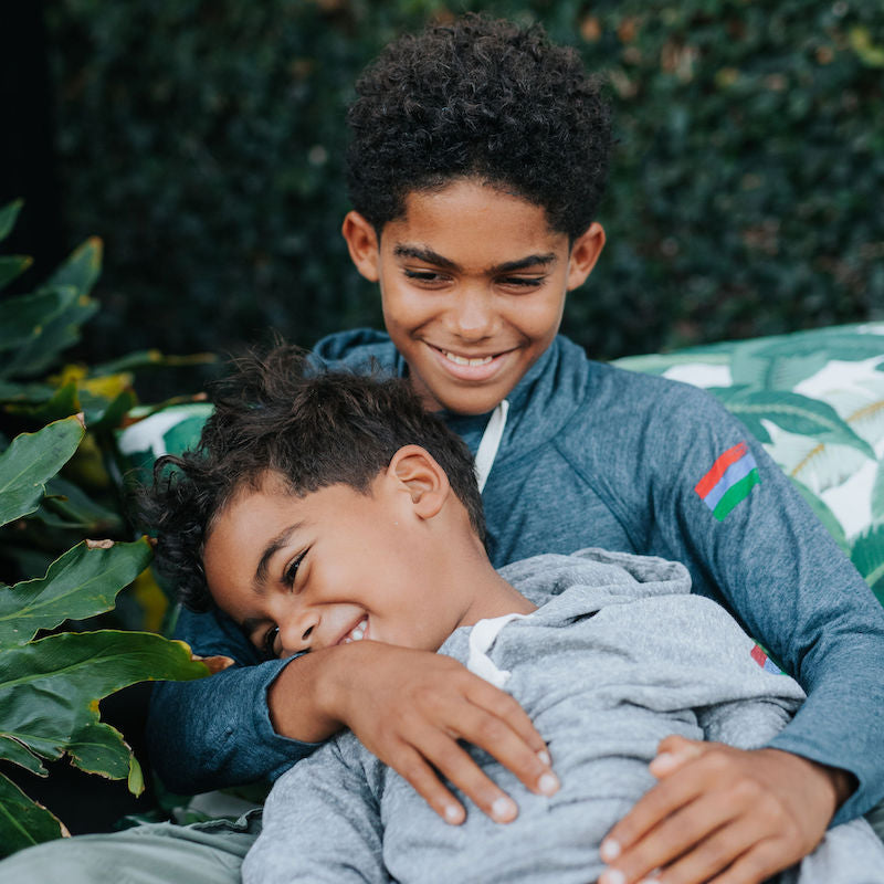 Photo of two brothers in a navy and a grey bucket list hoodie. 